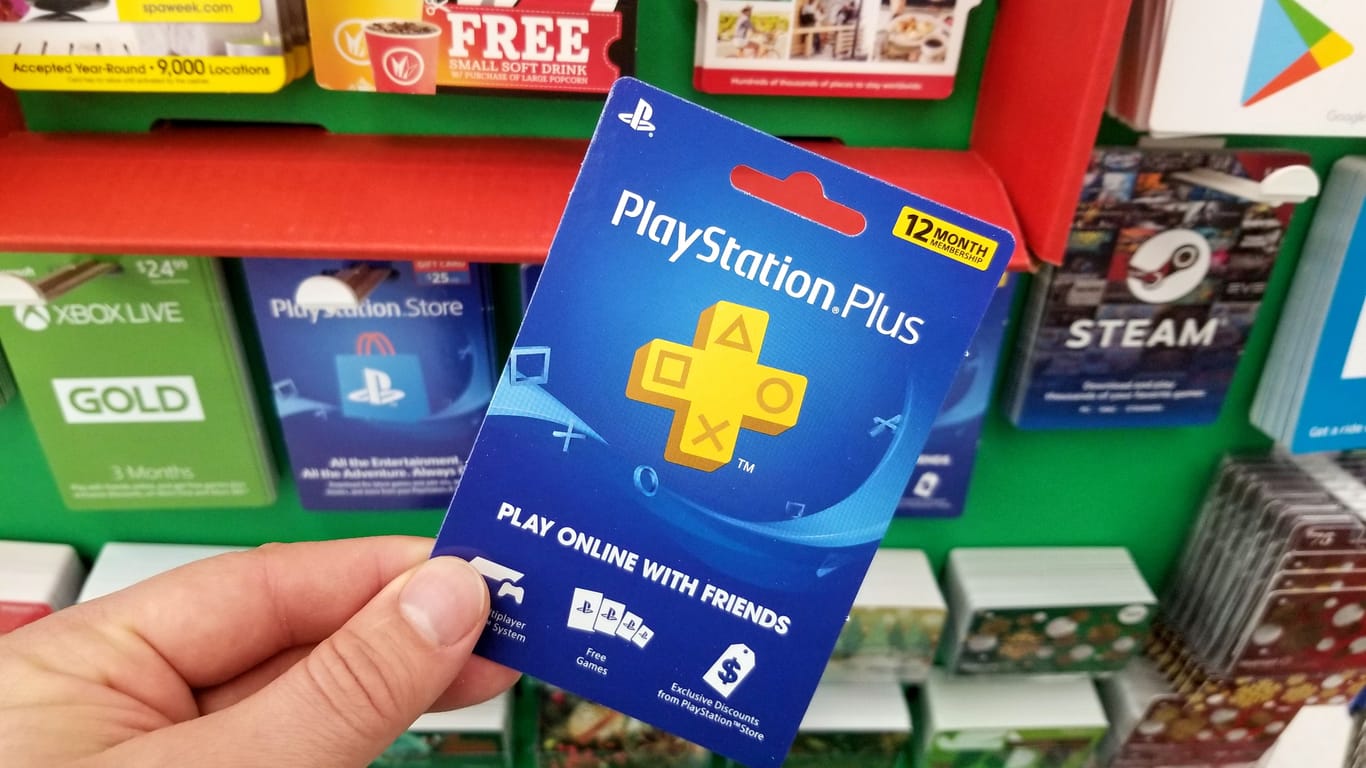 Play Station Plus gift card in a hand