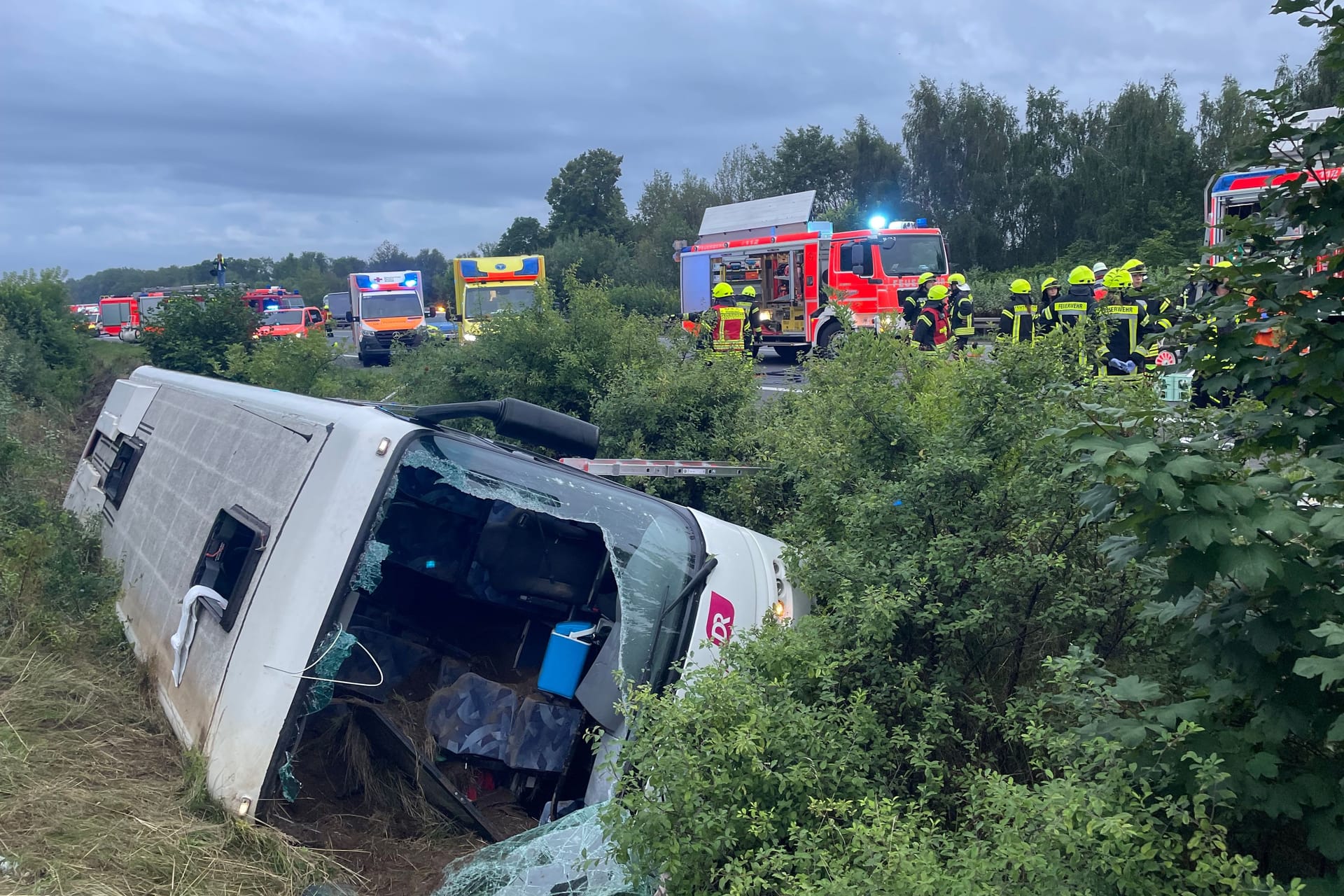 Der verunglückte Reisebus liegt in der Böschung: Bei dem Unfall wurden am Samstagmorgen etliche Personen schwer verletzt.