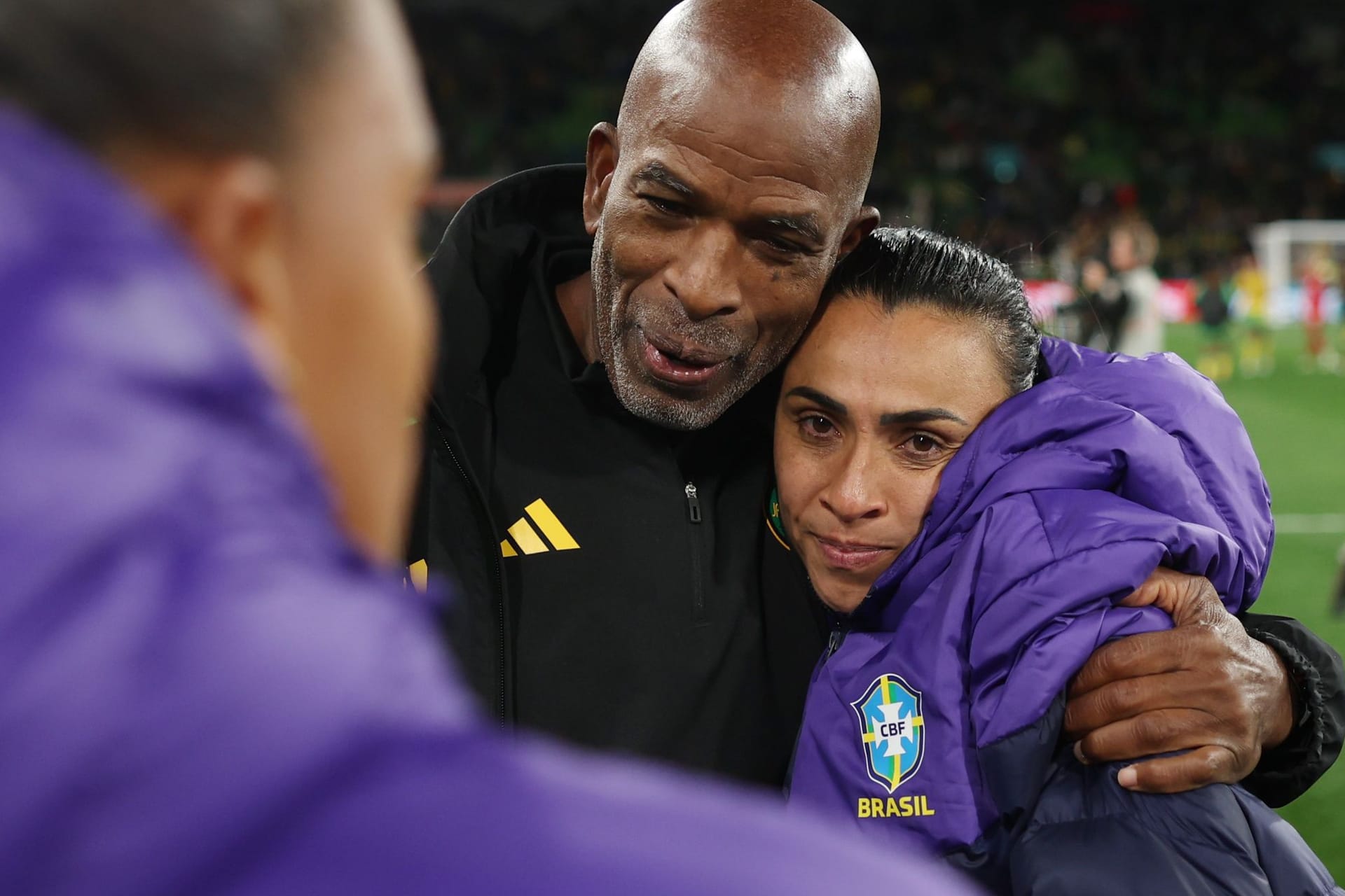 Jamaikas Coach Lorne Donaldson tröstet Brasiliens Marta.