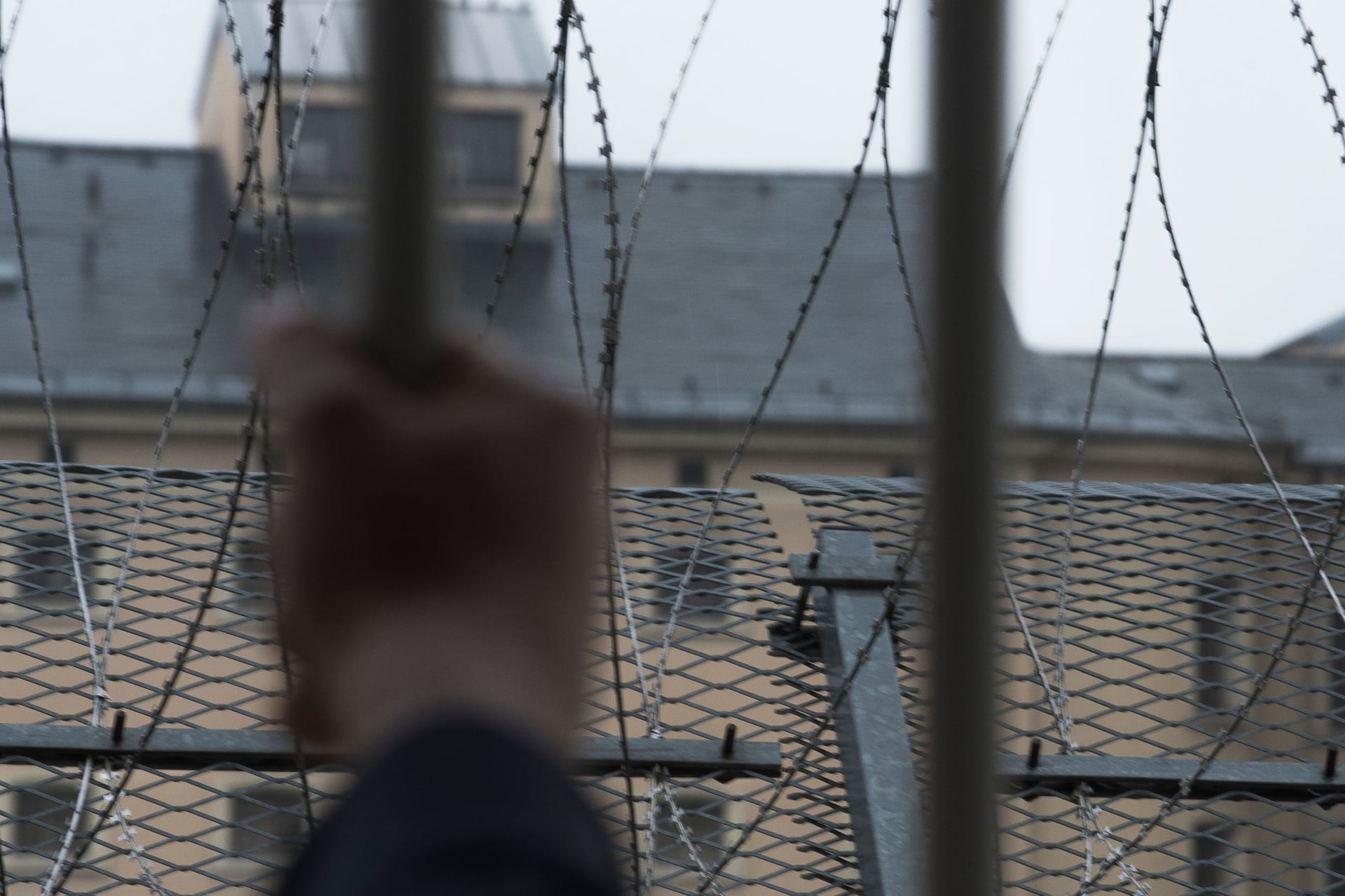 prisoner at the window of a prison cell