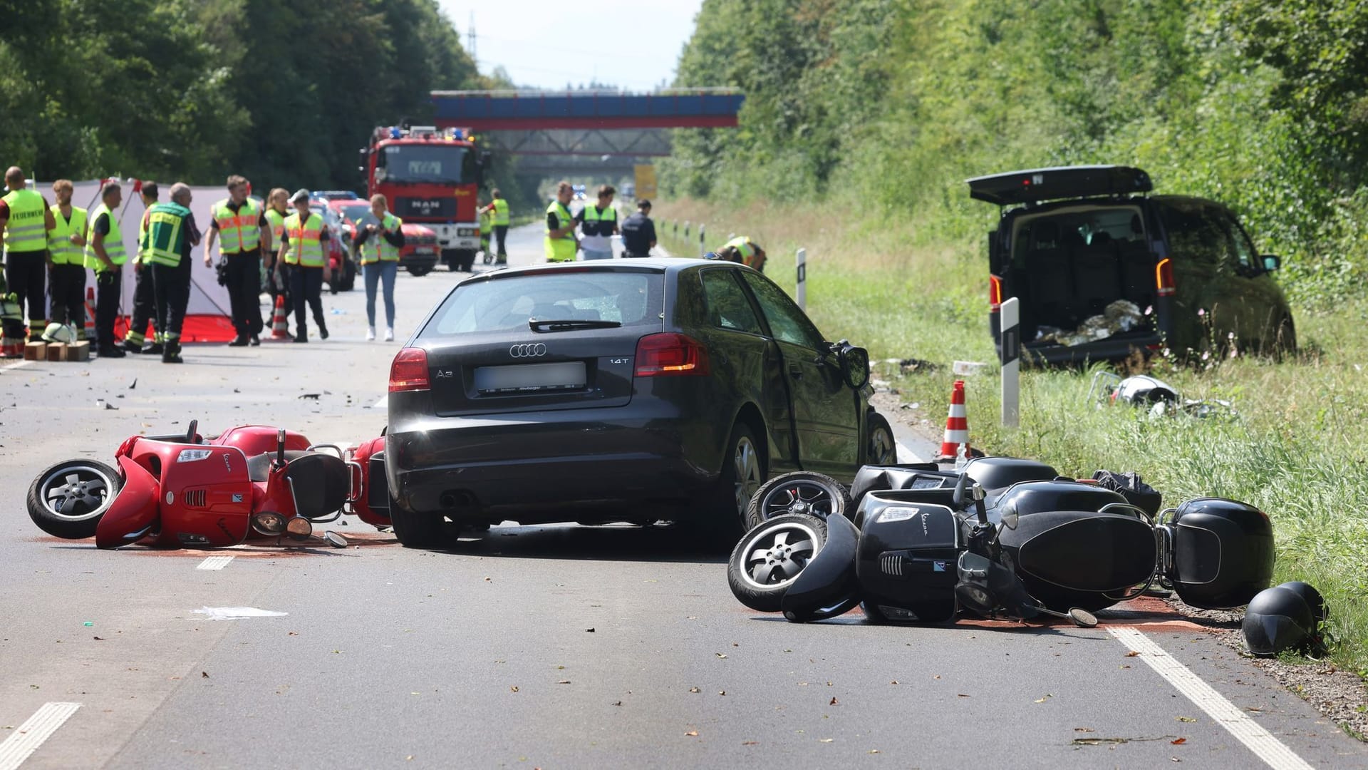 Beschädigte Motorroller liegen auf der Bundesstraße 17 um ein zerstörtes Auto: Bei dem Unfall sind laut Polizei mehrere Menschen teils schwerst verletzt worden.