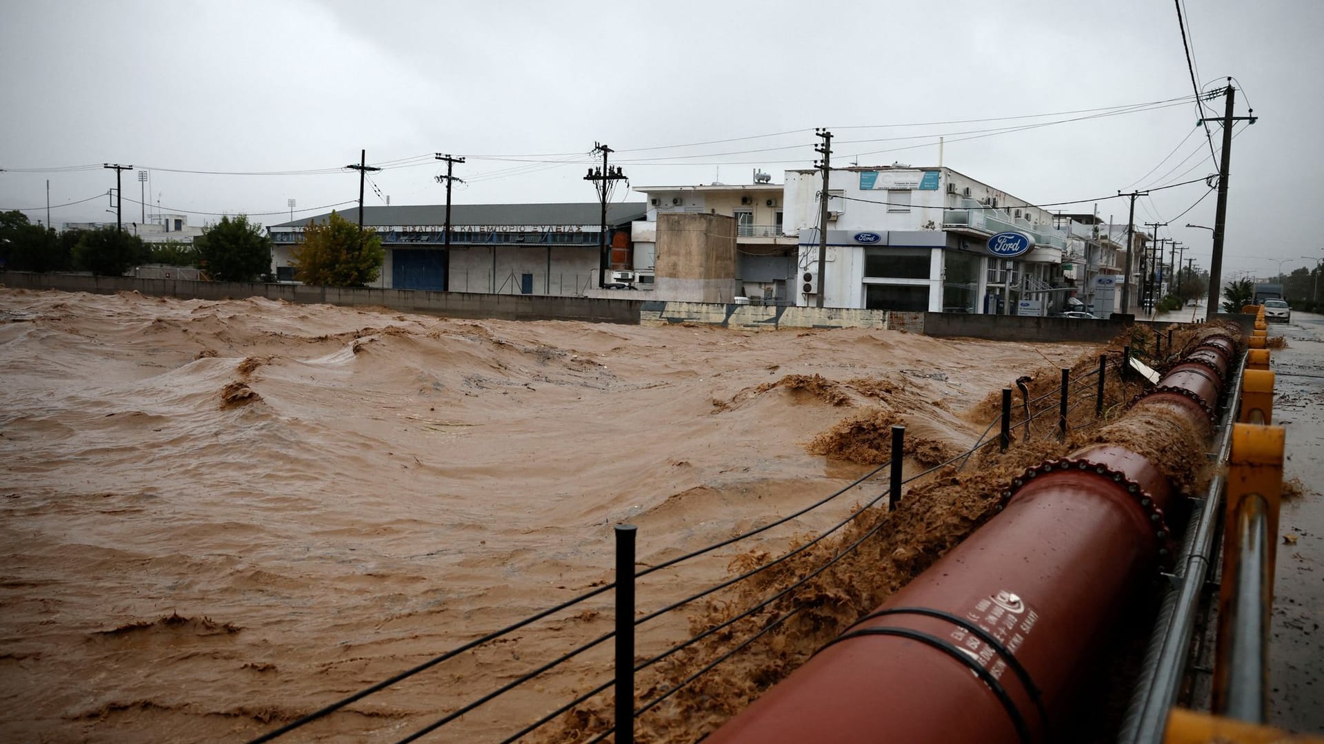 The waters of a river rise as a storm hits the city of Volos, Greece