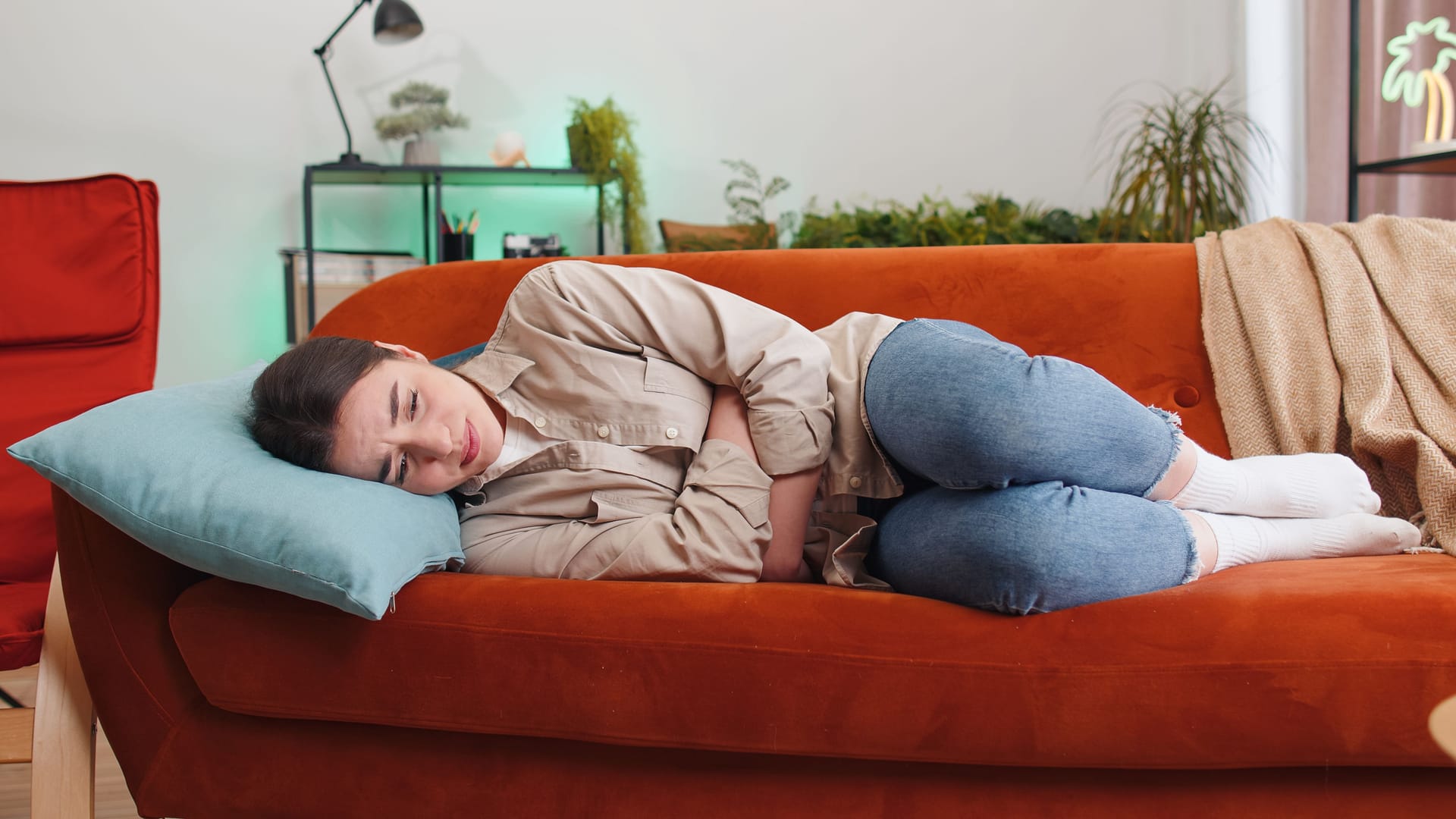 Eine Frau liegt auf dem Sofa.