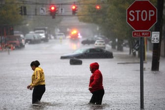 Menschen laufen durch die überfluteten Straßen: In New York hat heftiger Regen zu Überschwemmungen geführt.