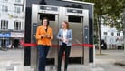 Die Senatorin Kathrin Moosdorf zusammen mit der Vorständin der Bremer Stadtreinigung, Daniela Enslein, vor einer der beiden neuen Toilettenanlagen auf dem Bahnhofsvorplatz.