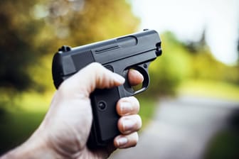 Person mit Waffe in der Hand (Symbolbild): In Neukölln ist ein Mann ausgeraubt worden.