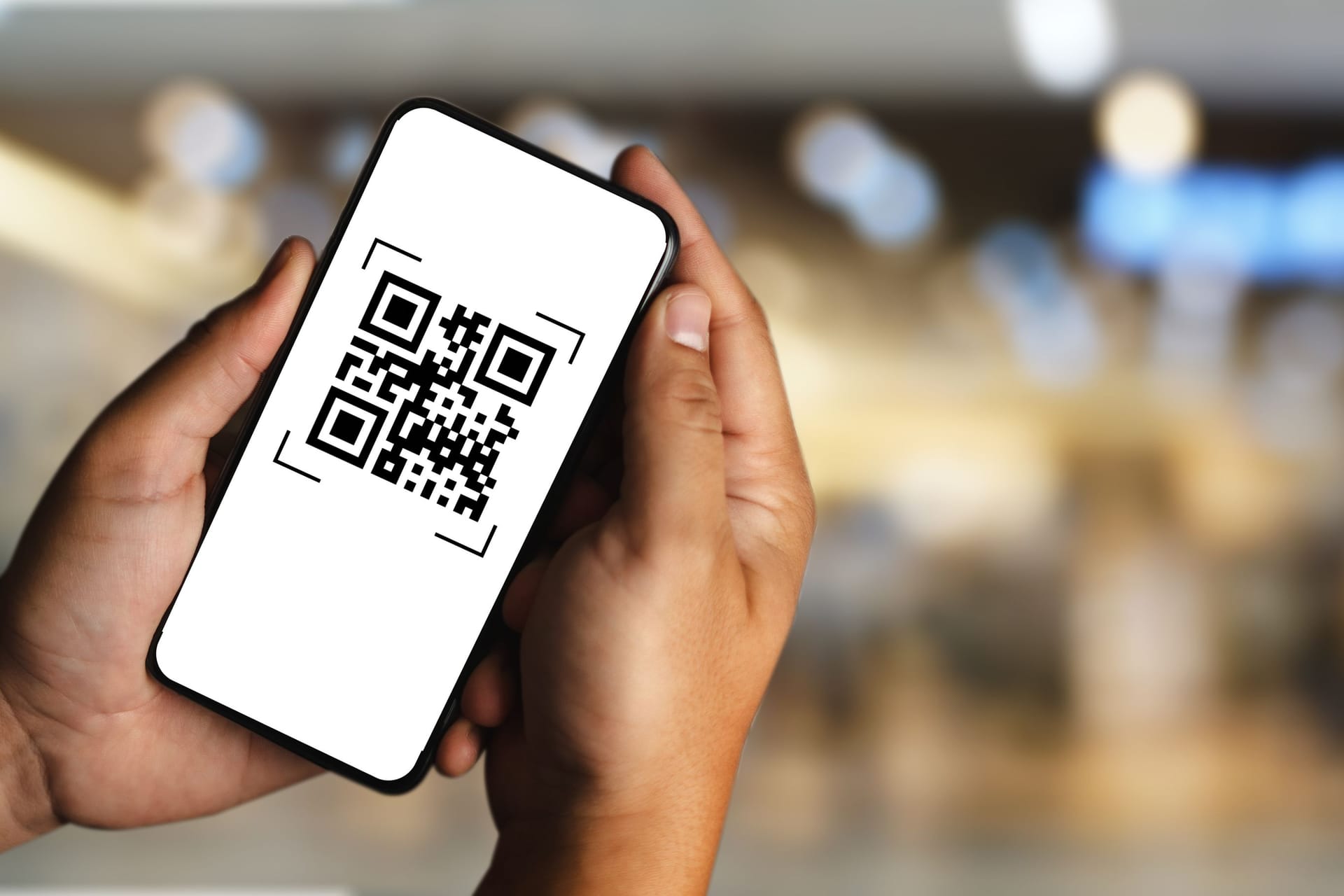 scanning QR codes with a mobile phone application and paying for goods and services in the retail supermarket background