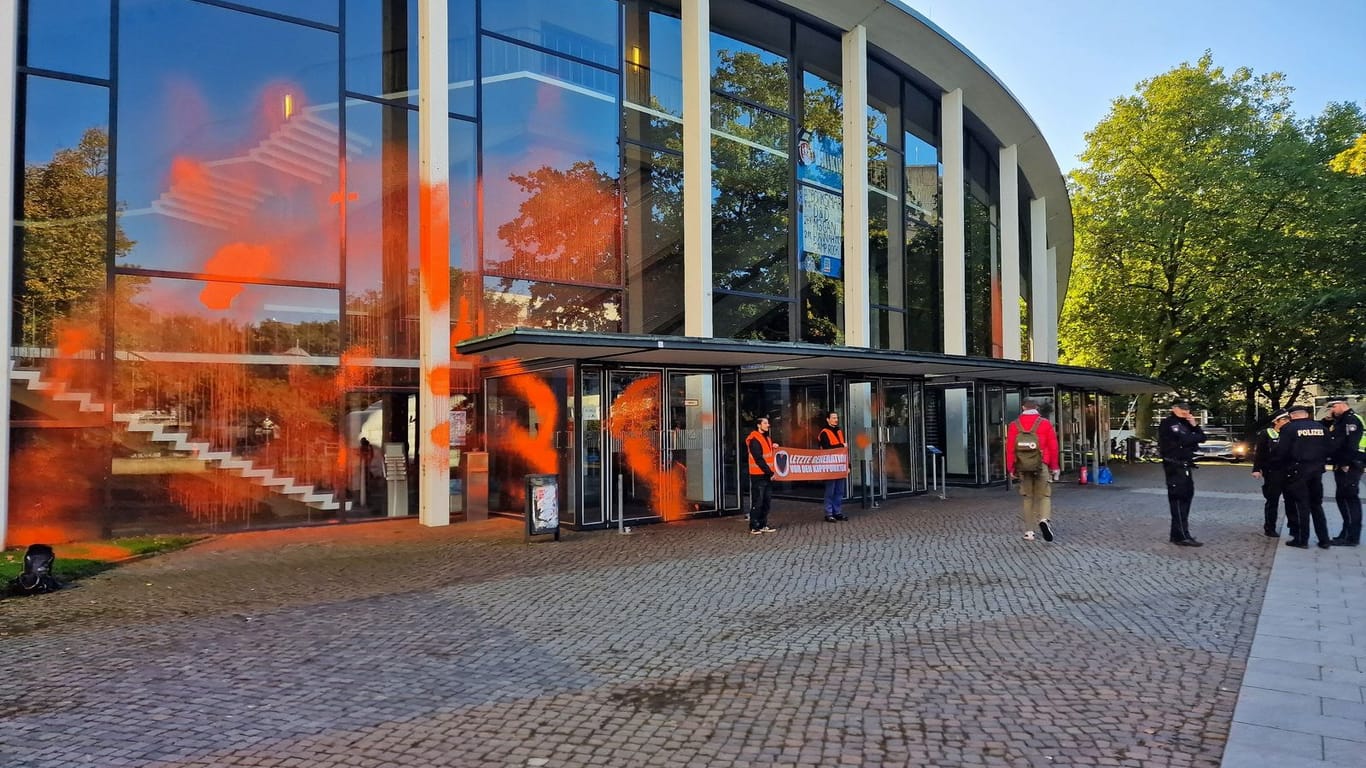Farbattacke: Klimaaktivisten haben orangefarbene Sprühfarbe auf der gläsernen Fassade hinterlassen.