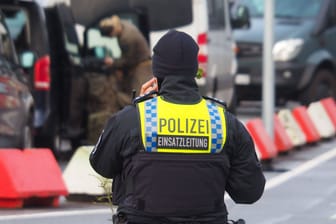 Ein Polizist steht am Einsatzort am Hamburger Flughafen: Dort läuft seit Samstagabend eine Geiselnahme.