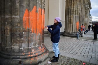 Berlin: Zwei Klimaaktivistinnen bemalen das Brandenburger Tor mit oranger Farbe. Die Gruppe Letzte Generation teilte am Donnerstag mit, dass Mitglieder mit Pinseln die Westseite des Bauwerks eingefärbt haben