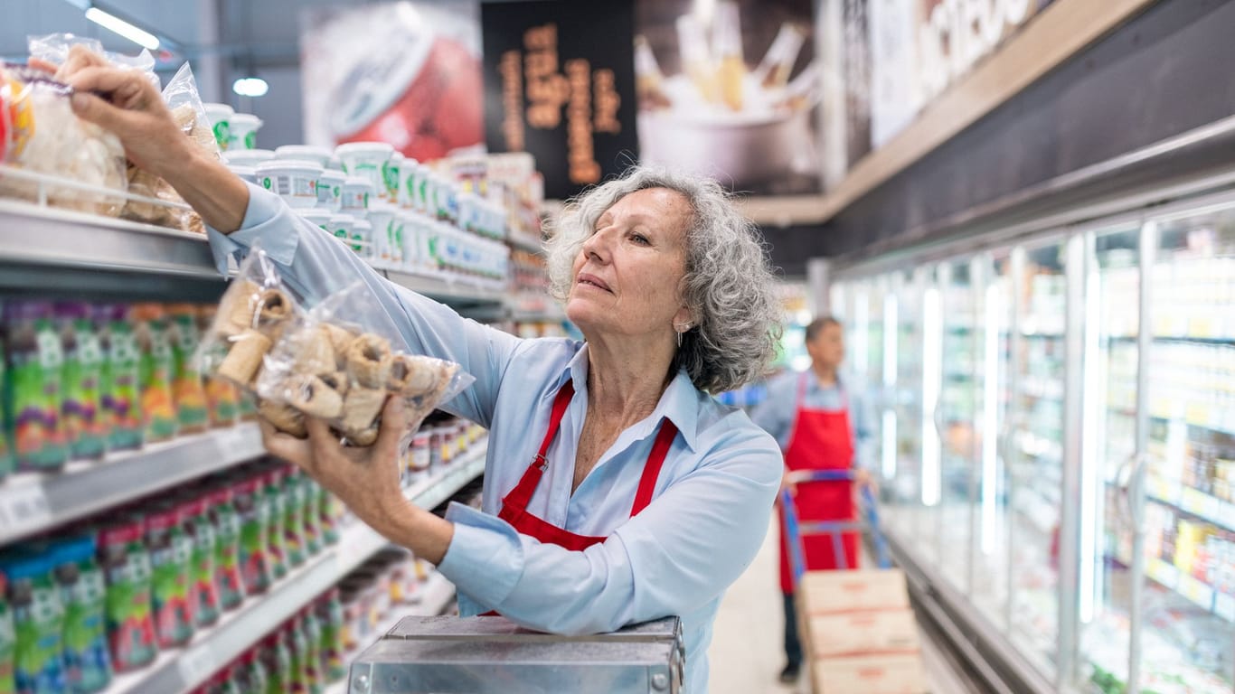 Rentnerin arbeitet im Supermarkt: Beim Hinzuverdienst zur Rente gibt es seit 2023 neue Regeln.