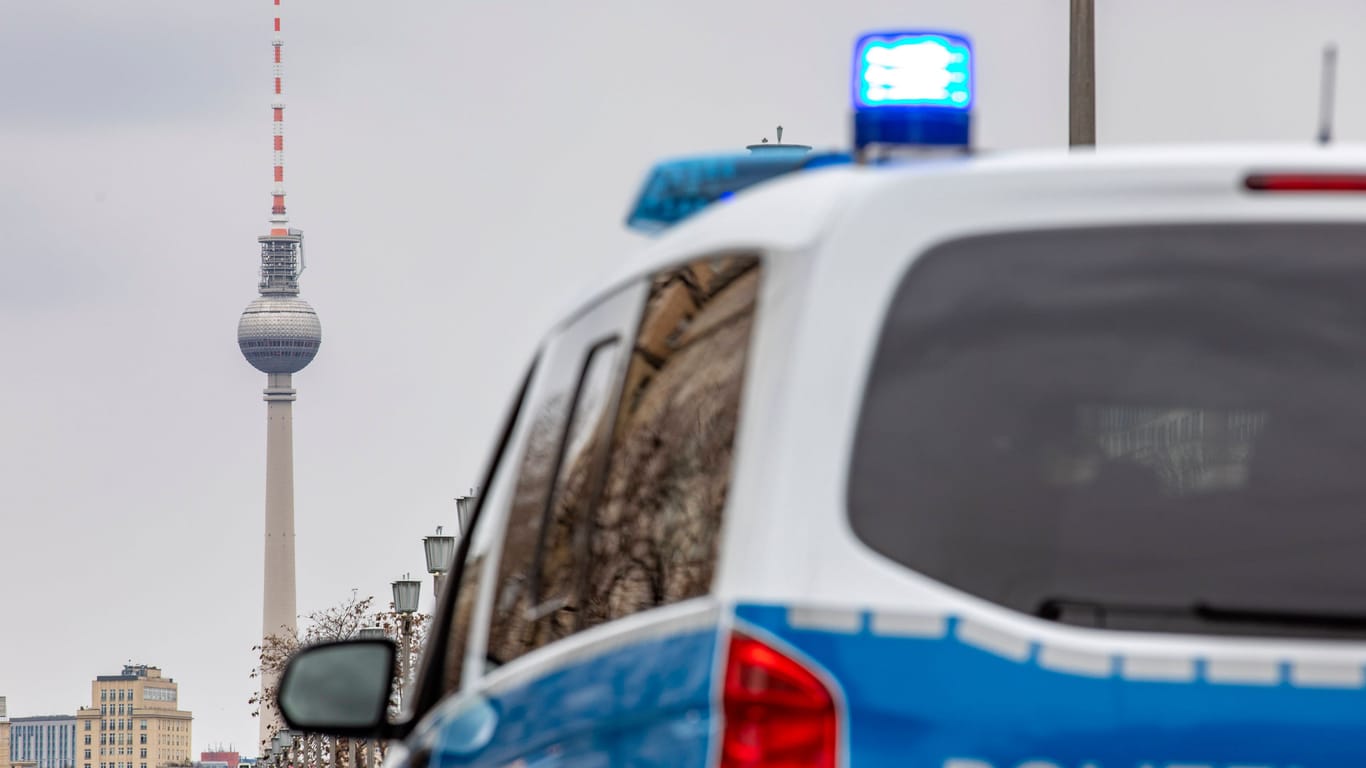 Ein Streifenwagen der Berliner Polizei mit Blaulicht, im Hintergrund ist der Fernsehturm am Alexanderplatz zu sehen (Symbolbild): Am Alex kam es zu einer Gewalttat.