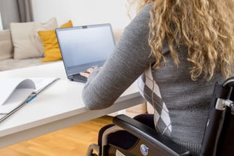 Eine Frau sitzt am PC und tippt