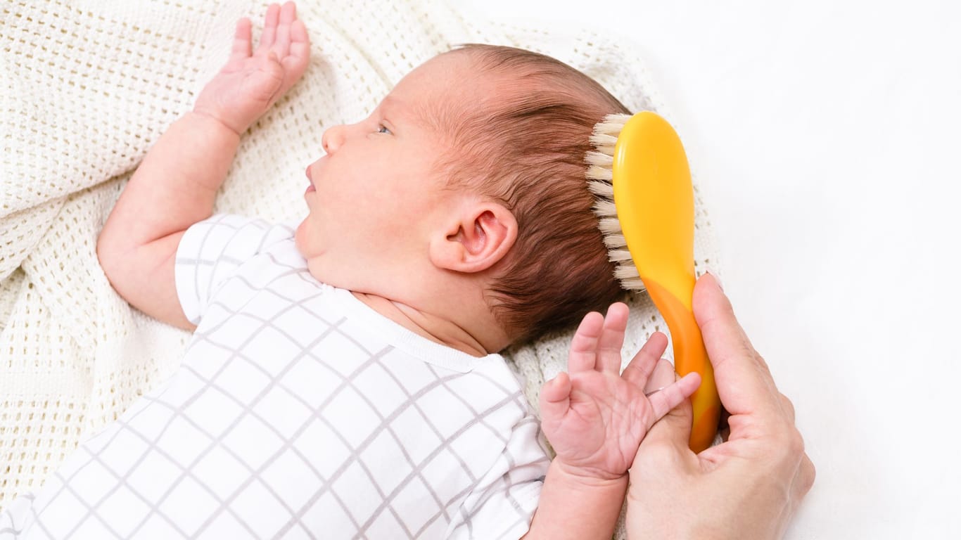 Mithilfe einer weichen Babybürsten können gelockerte Hautschuppen sanft entfernt werden.