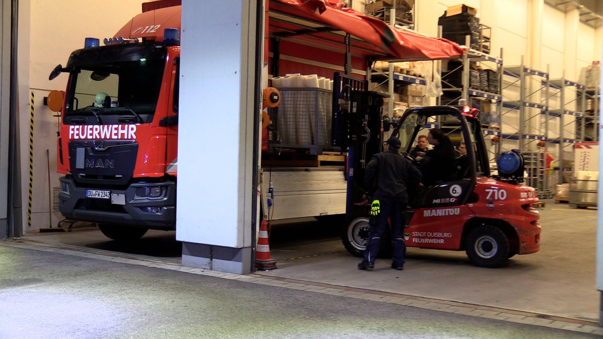 Feuerwehrleute beladen einen Lkw für den Transport des Hochwasserschutzsystems nach Oldenburg.