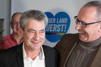 Tim Lochner (l), der für die Oberbürgermeisterwahl von der AfD aufgestellte Kandidat, und Jörg Urban, Vorsitzender der AfD in Sachsen, freuen sich während der Wahlparty ihrer Partei.