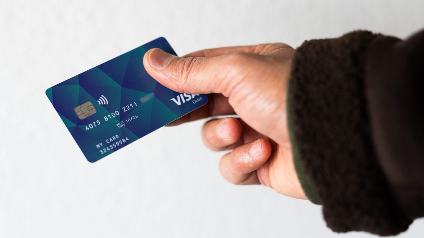 Eine Person hält eine Debitkarte in der Hand (Symbolfoto): Bund und Länder hatten sich im November auf die Einführung von Bezahlkarten für Geflüchtete geeinigt.