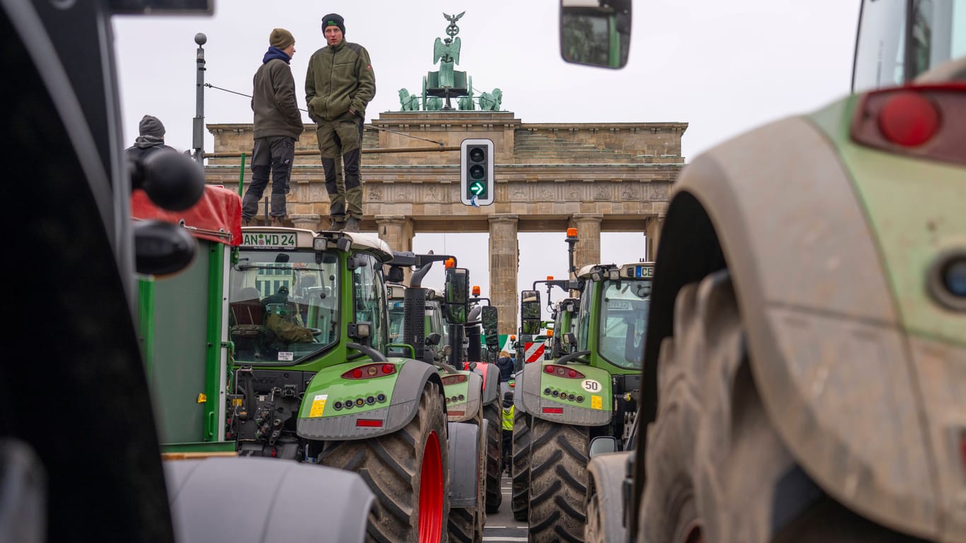 Bauern mit Traktoren aus ganz Deutschland protestieren vor dem Brandenburger Tor gegen geplante Einsparungen durch die Bundesregierung