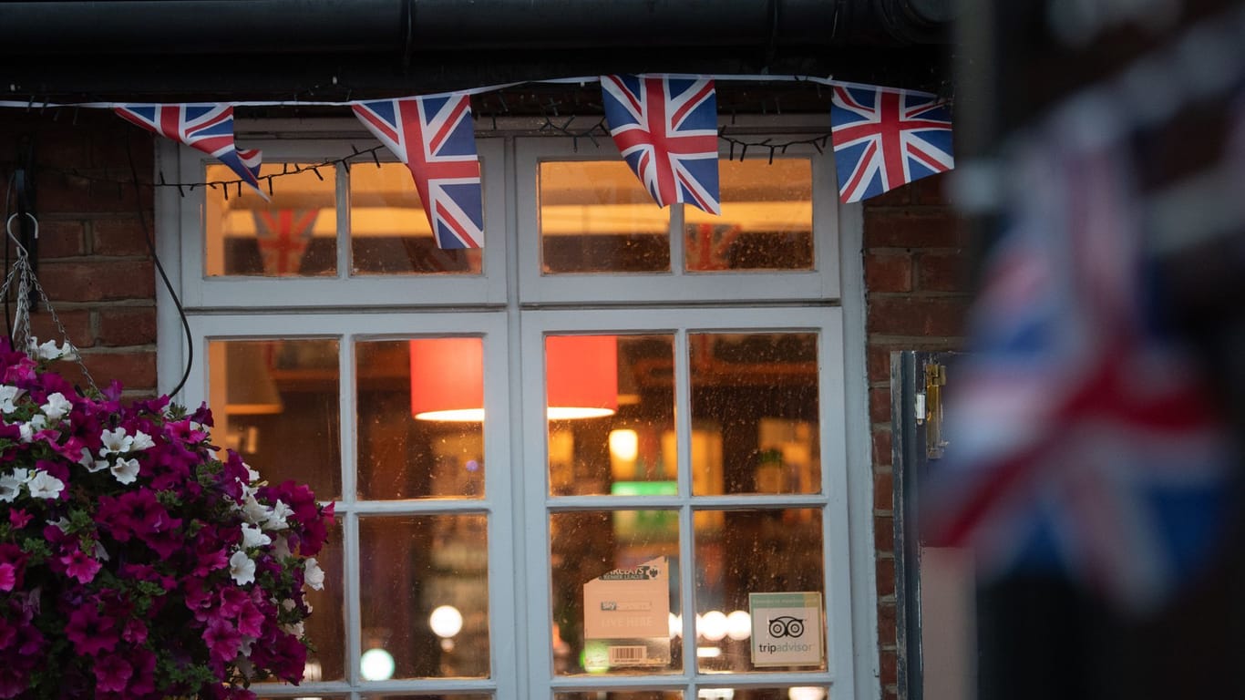 Union-Jack-Fahnen hängen an dem Fenster eines Pubs (Symbolbild): Ein Online-Trinkspiel geht derzeit in England viral.