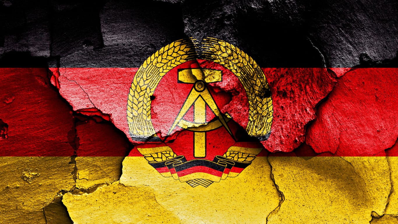 Die Flagge der DDR gemalt auf einer kaputten Wand