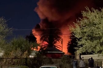 A plume of smoke rises after a small plane crashes in a trailer park in Clearwater, Florida