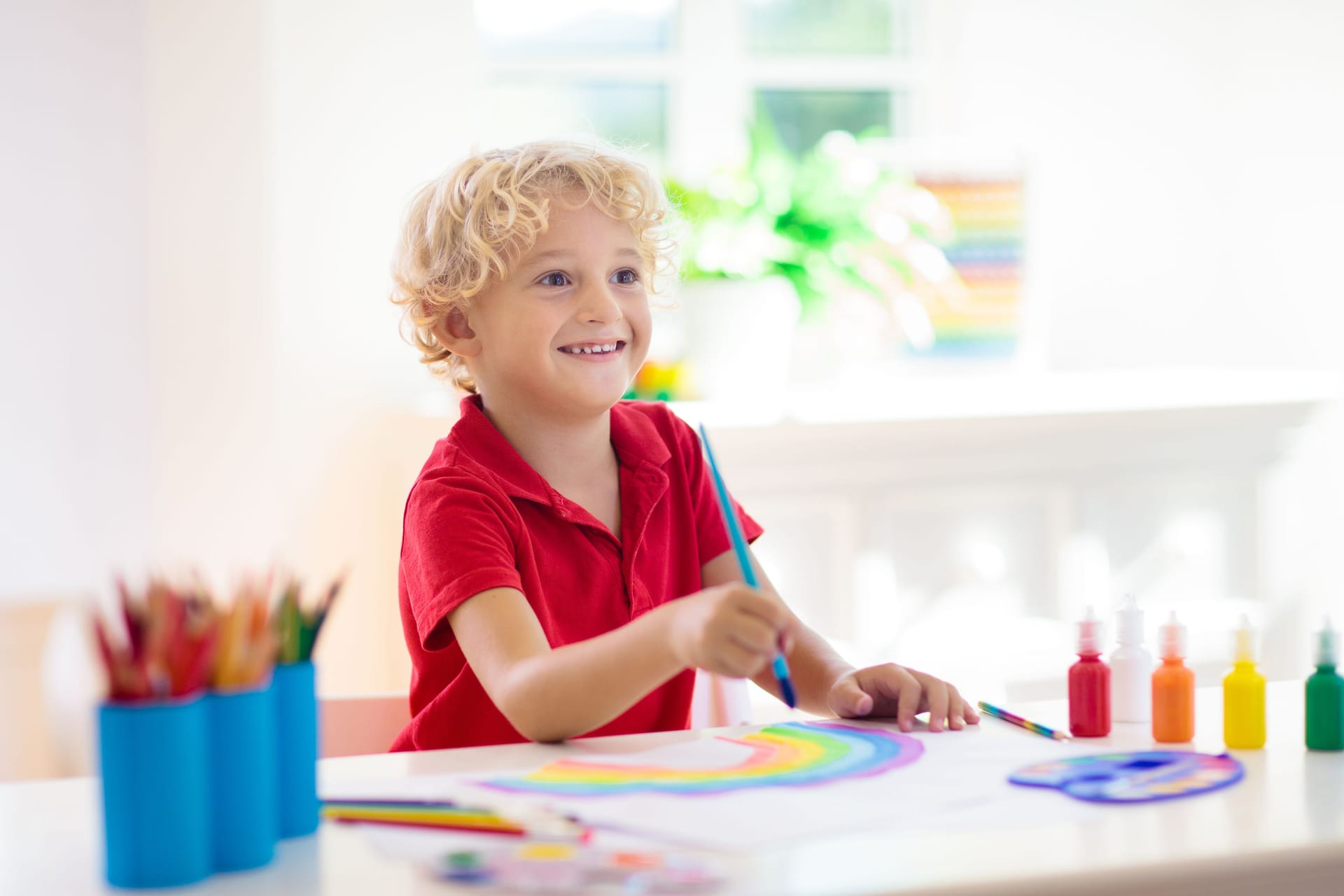 Kids paint. Child painting. Little boy drawing.