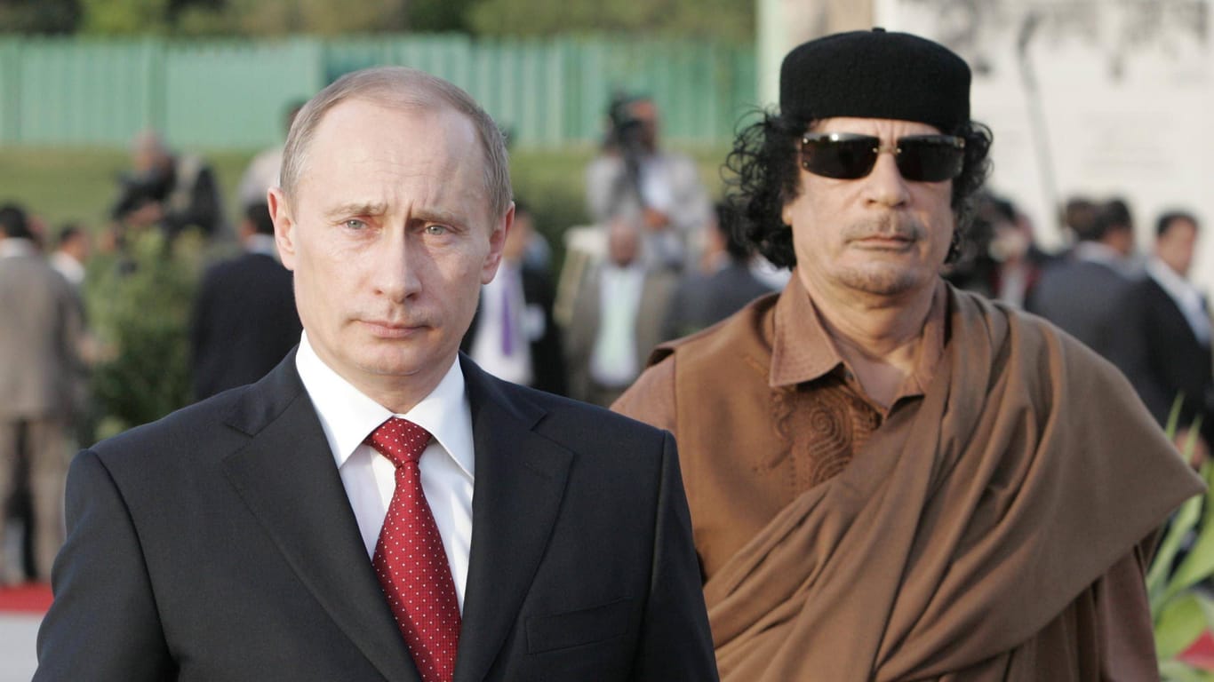 Wladimir Putin mit Muammar al-Gaddafi: Russlands Präsident will nicht enden wie der libysche Diktator.