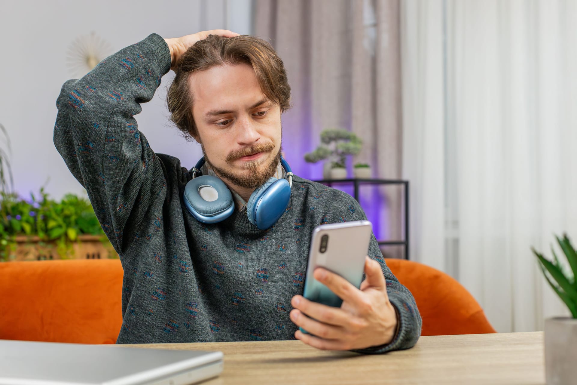 Sad bearded man use smartphone surprised by bad news, fortune loss, fail, lottery results, deadline