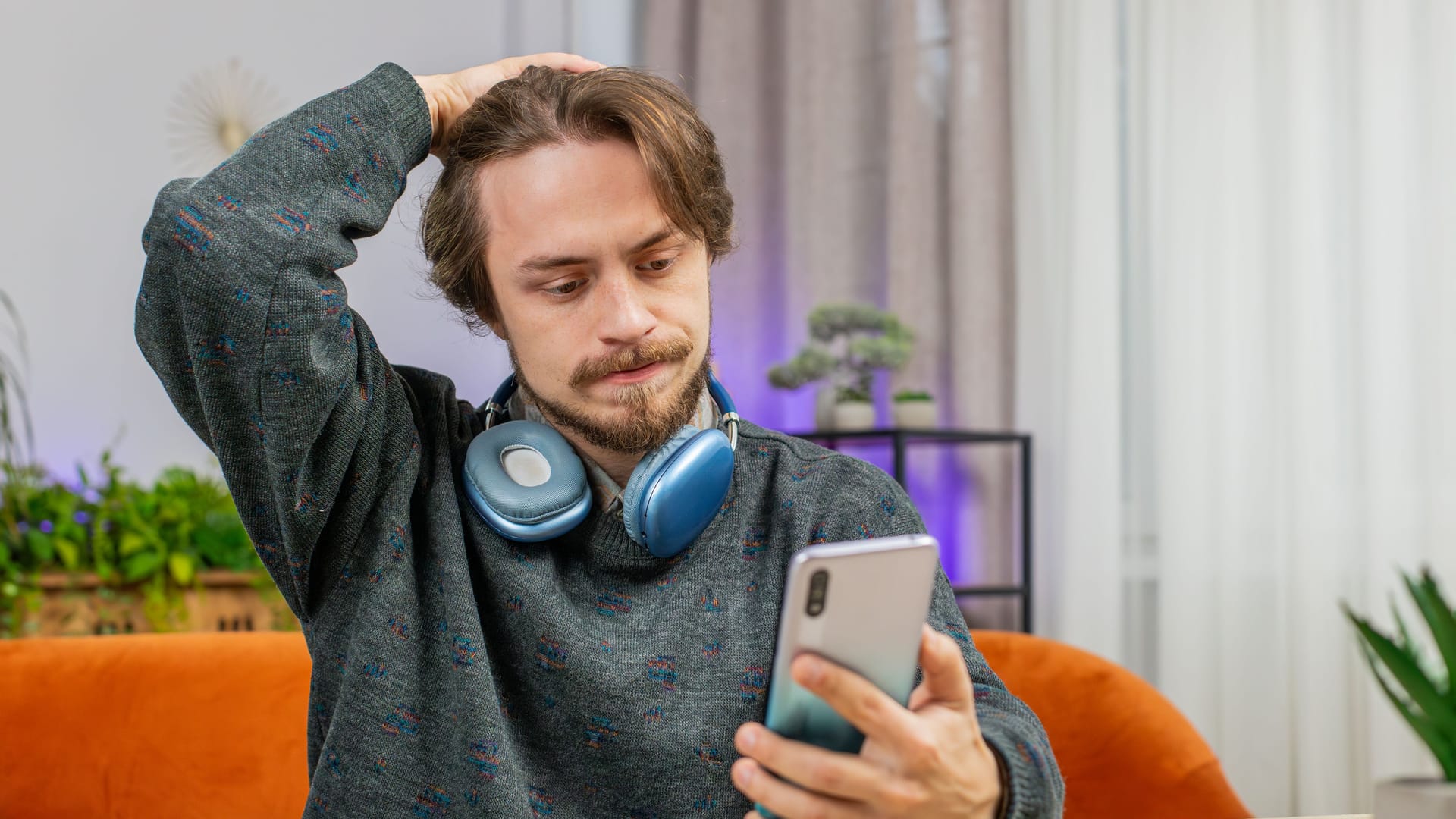 Sad bearded man use smartphone surprised by bad news, fortune loss, fail, lottery results, deadline