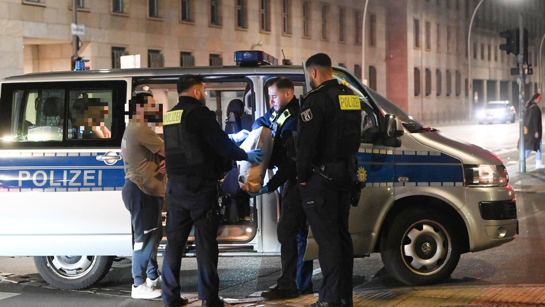 Polizisten untersuchen Tatverdächtige auf Schmauchspuren am Checkpoint Charlie. Zuvor war dort auf einen Mann geschossen worden.