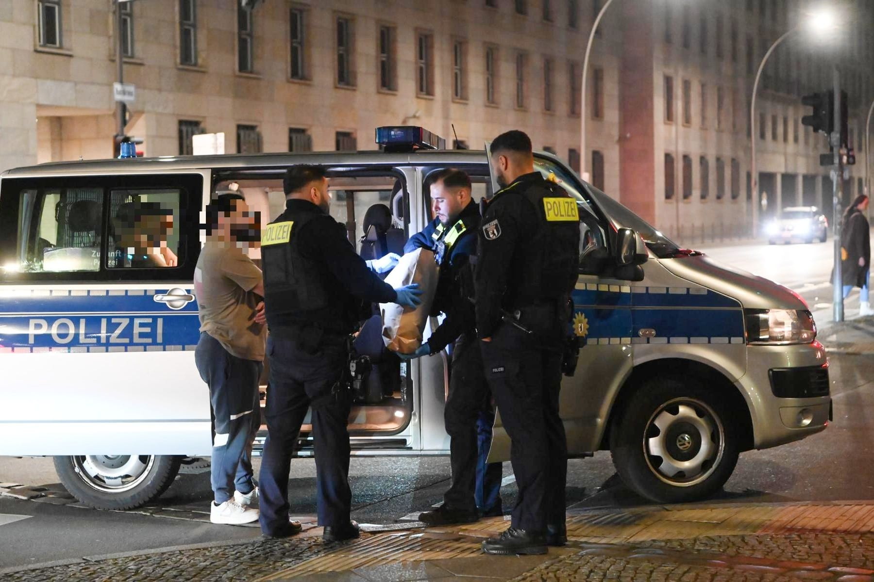 Polizisten untersuchen Tatverdächtige auf Schmauchspuren am Checkpoint Charlie. Zuvor war dort auf einen Mann geschossen worden.