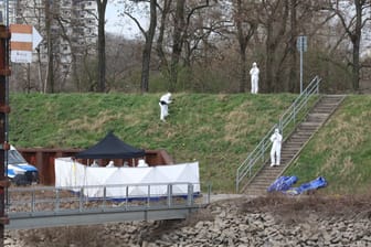 Köln: Polizisten untersuchen am Fundort einer Leiche die Umgebung.