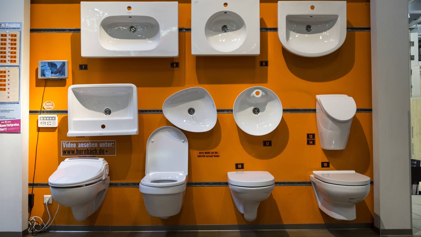 Toilettenschüsseln und Spülbecken hängen zu Ausstellungszwecken in einem Baumarkt (Symbolbild): Ein Reinigungsmitarbeiter musste die widerliche Hinterlassenschaft wegmachen.