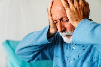 Senior man suffering from headache. Healthcare illness people concept