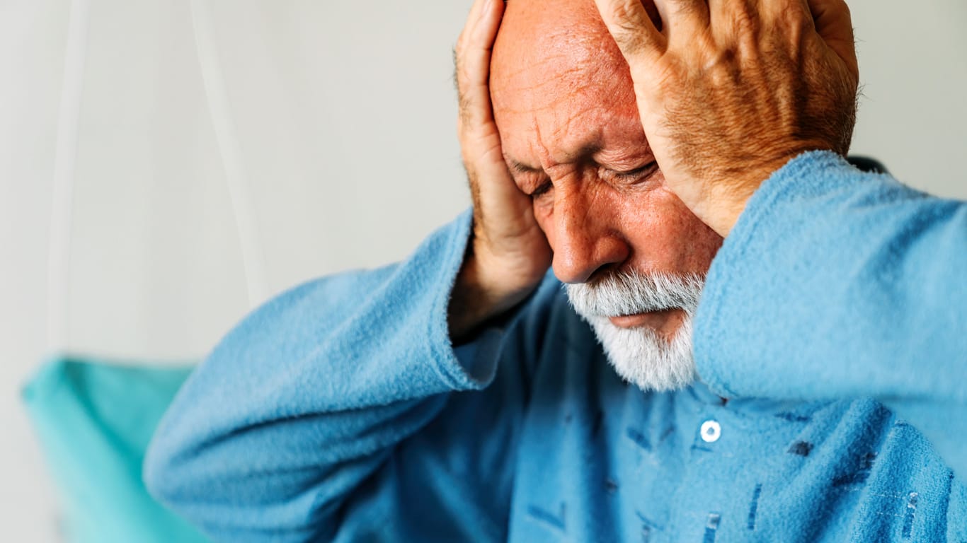 Senior man suffering from headache. Healthcare illness people concept
