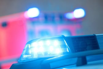 Einsatzwagen der Polizei mit eingeschaltetem Blaulicht und Notarzt Rettungswagen bei einem Einsatz in der Innenstadt Köln an Silvester