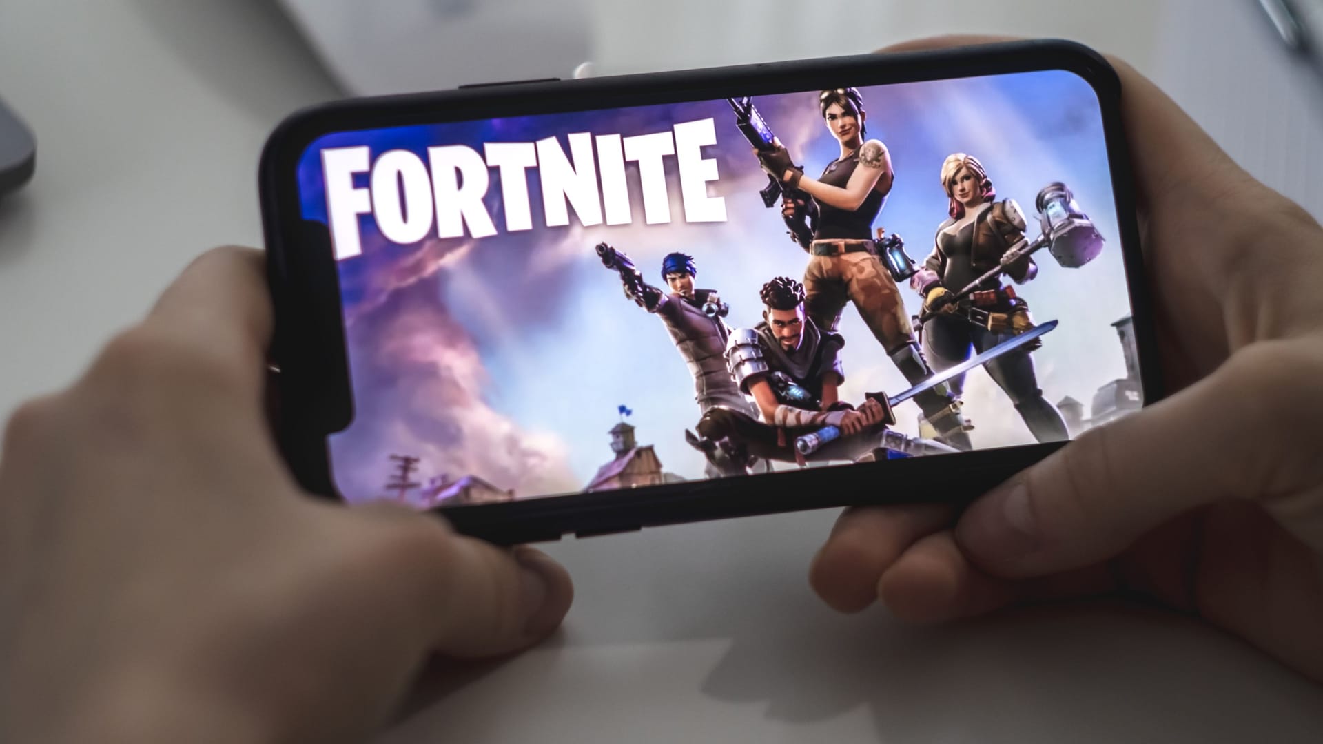 Fortnite game on the iPhone screen.