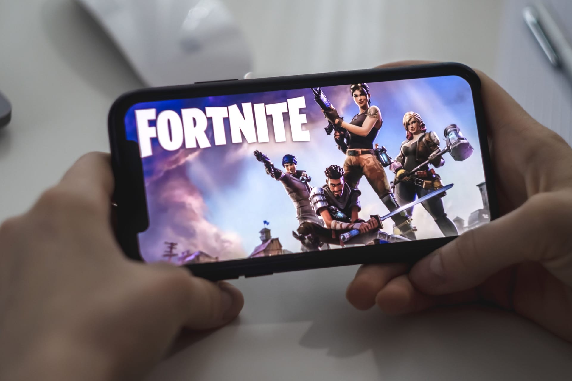 Fortnite game on the iPhone screen.