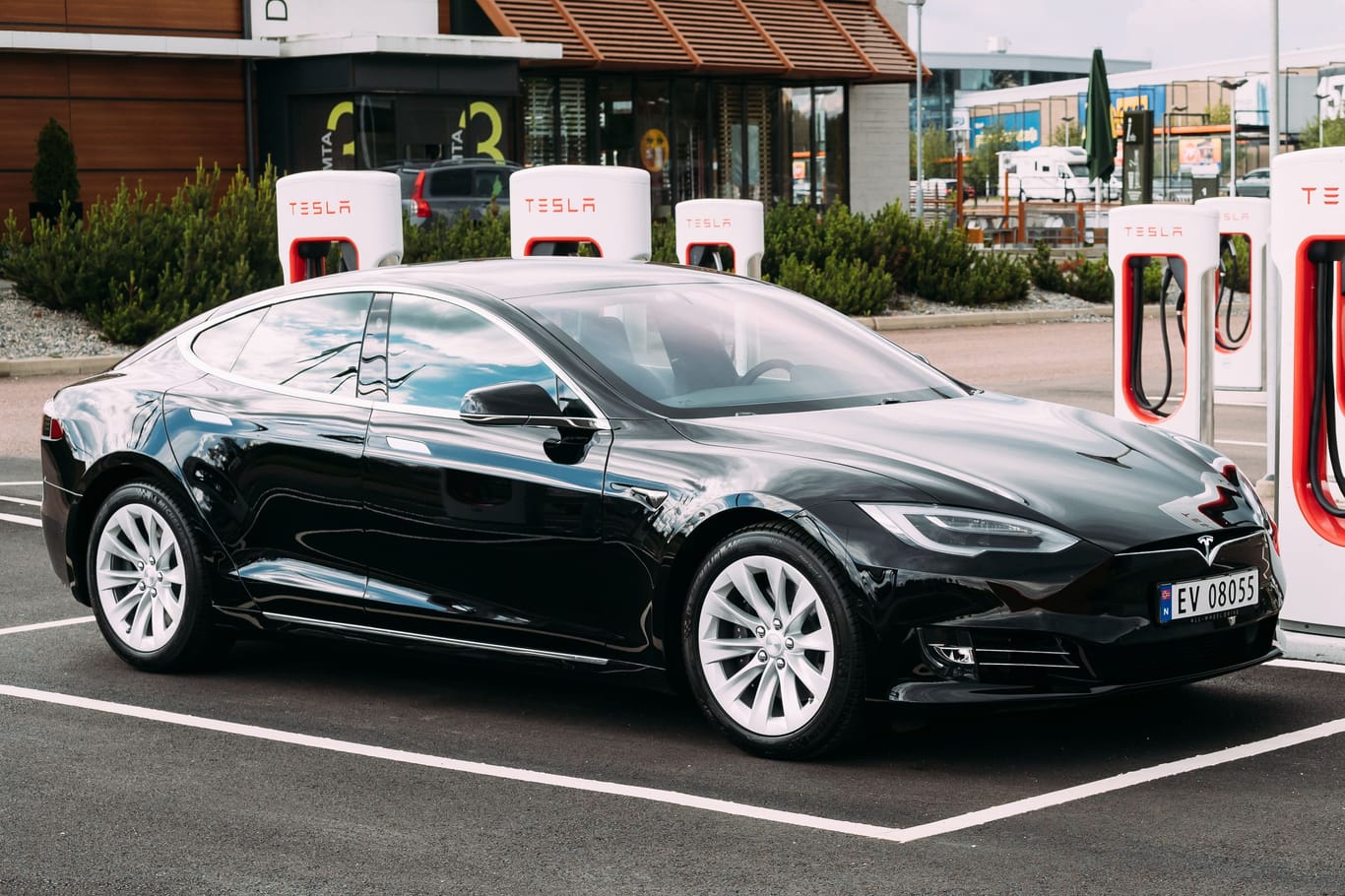 Black Color Tesla Model S 100d Car Parked At Charging Station. The Tesla Model S Is A Full-sized All-electric Five-door, Luxury Liftback, Produced By Tesla Inc.
