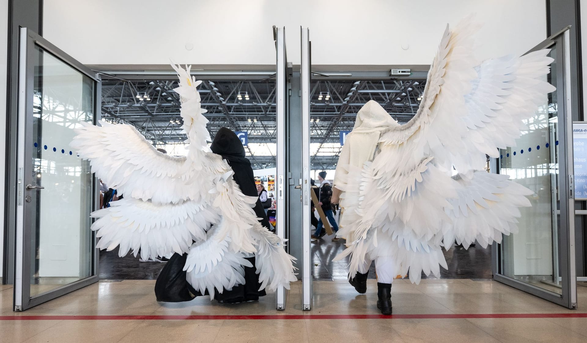 Zwei Cosplayerinnen betreten auf der Leipziger Buchmesse die Manga Halle.