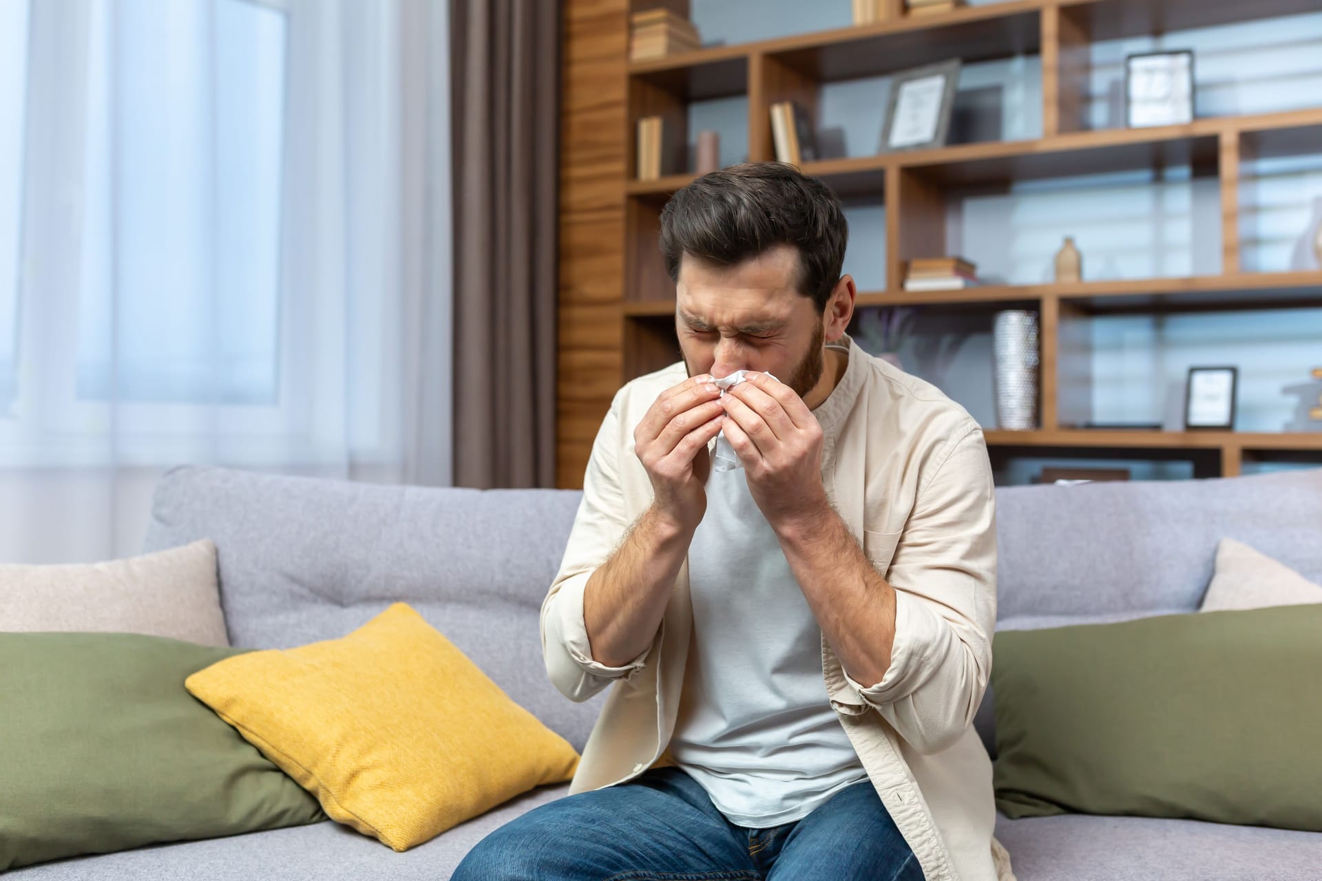 Mann mit Nasenbluten auf dem Sofa