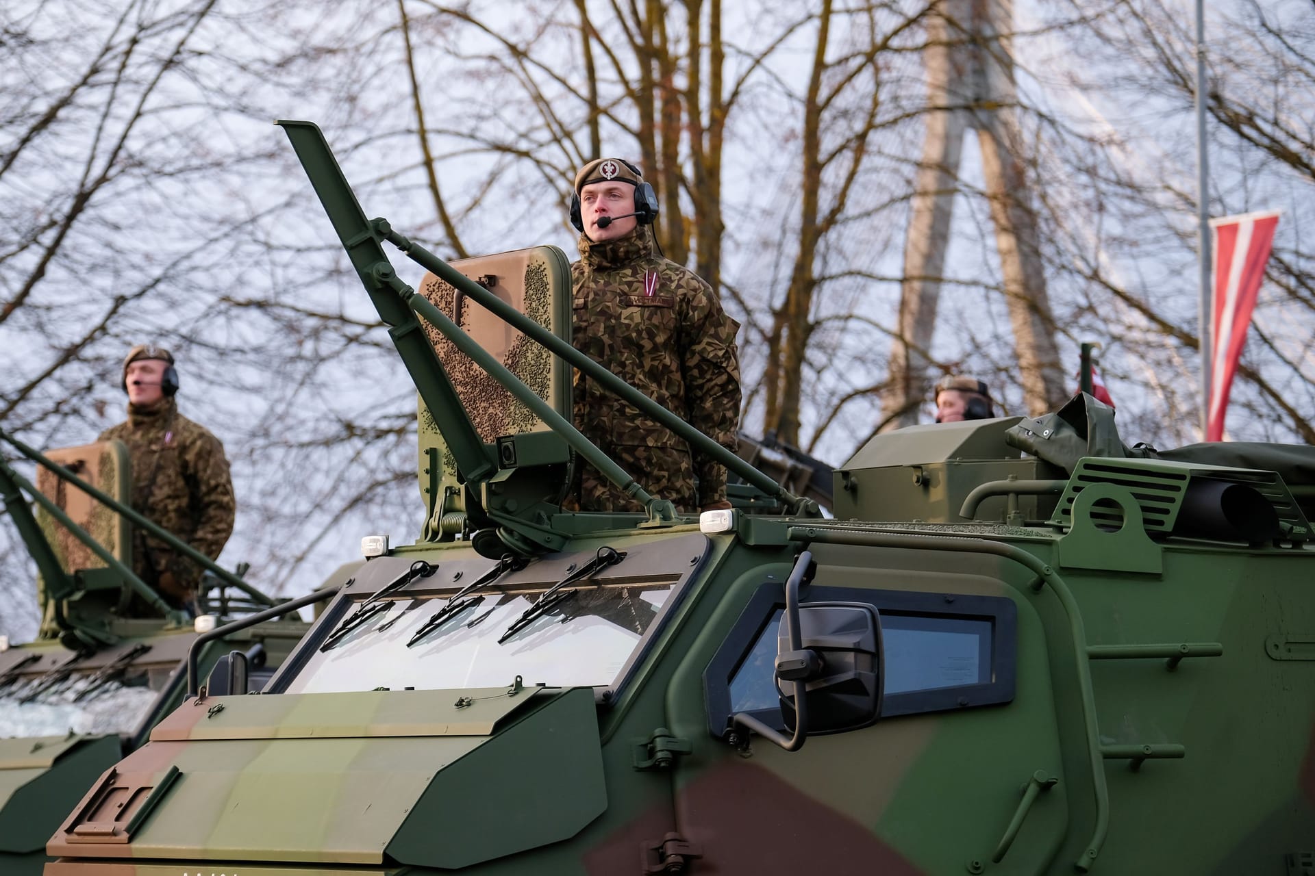 Riga, Latvia - November 18, 2022: Finnish made armoured personnel carrier Patria 6x6 of army of Latvia in a parade in the capital of Latvia, Riga. Defocused