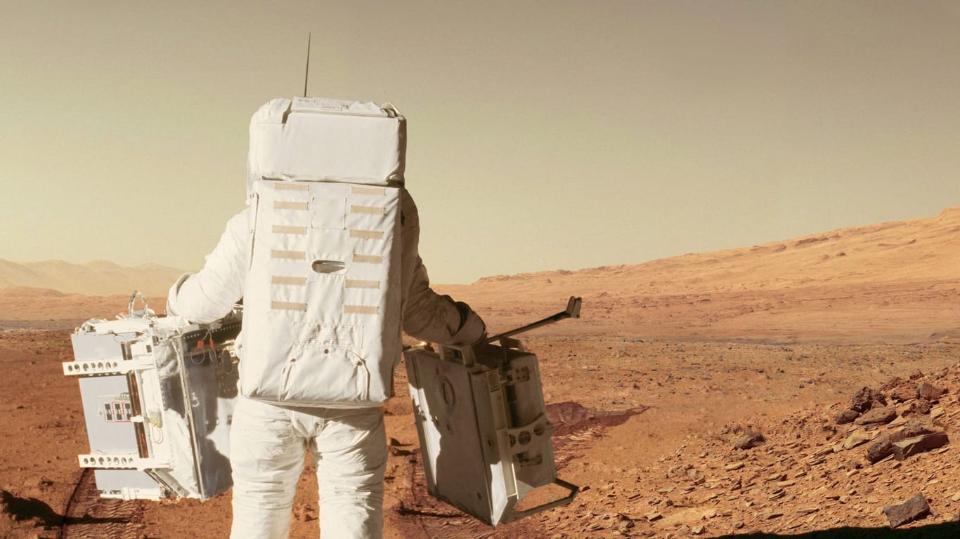 Ein Astronaut in einem Raumanzug auf dem roten Planeten Mars (Archivbild): Ein KI-Projekt aus Bremen könnte bei der Besiedlung des roten Planeten helfen.