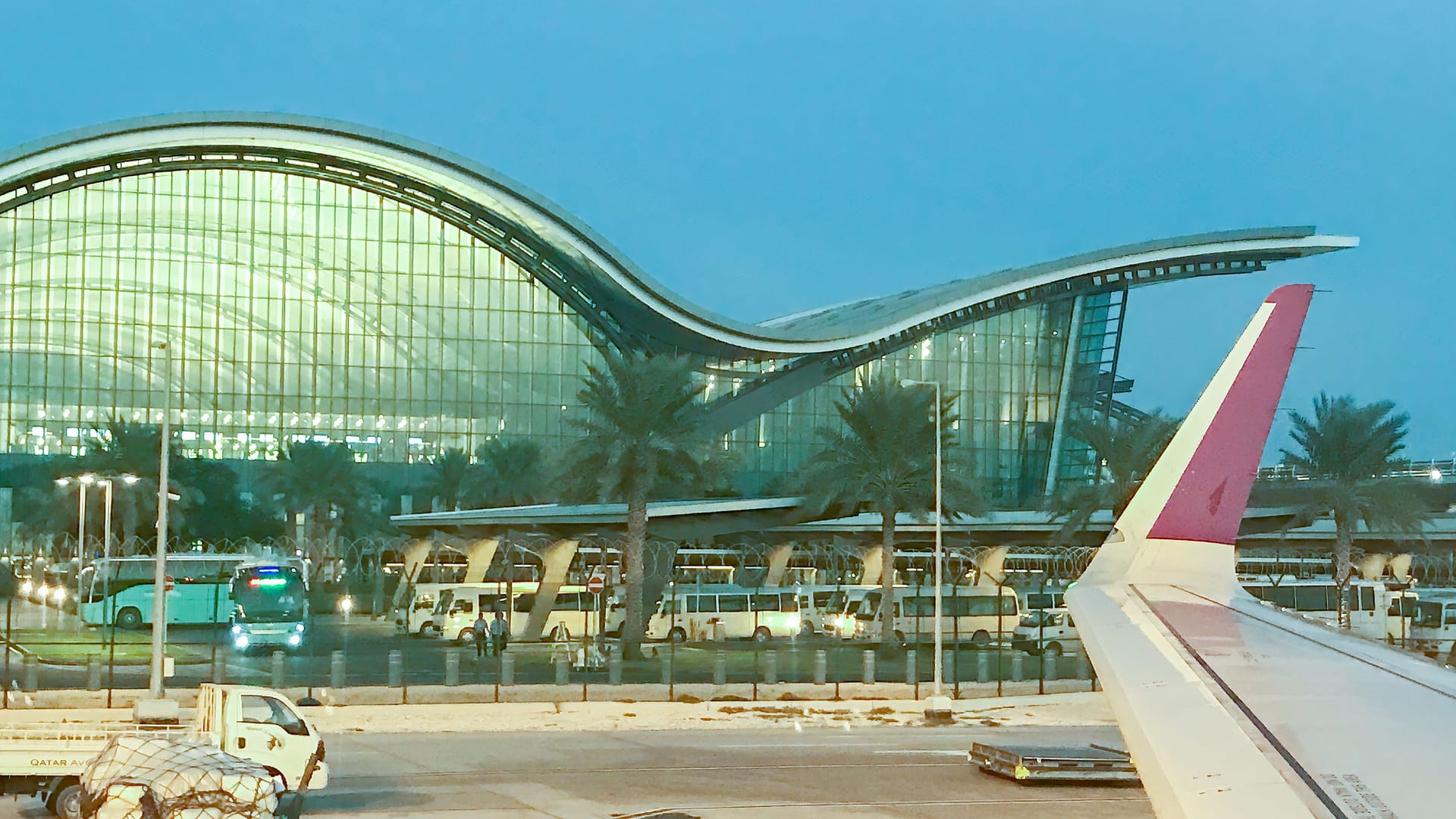 Doha, Qatar - December 3, 2016: Exterior of Hamad International Airport at night as seen from the airplane