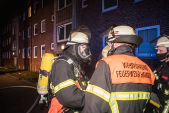 Einsatzkräfte der Feuerwehr Hamburg vor einem Mehrfamilienhaus (Symbolbild): Ein Nachbar hatte den Notruf gewählt, nachdem ein Rauchmelder Alarm schlug.