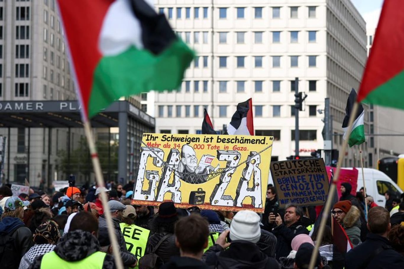 Pro-Palestinian demonstrators hold Palestinian flags and placards, as they demand "No weapons for Israel", during a protest march, amid the ongoing conflict between Israel and the Palestinian Islamist group Hamas, in Berlin, Germany