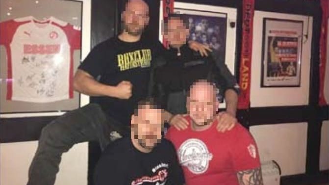 G. (rechts, stehend) mit Männern, die T-Shirts von "Standarte Bremen" und "Nordsturm Brema" tragen. Beide Gruppen galten trotz der geringen Größe (zusammen 40 Mitglieder) als äußerst schlagkräftig.