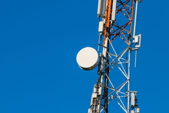 Communications tower with antennas on blue sky