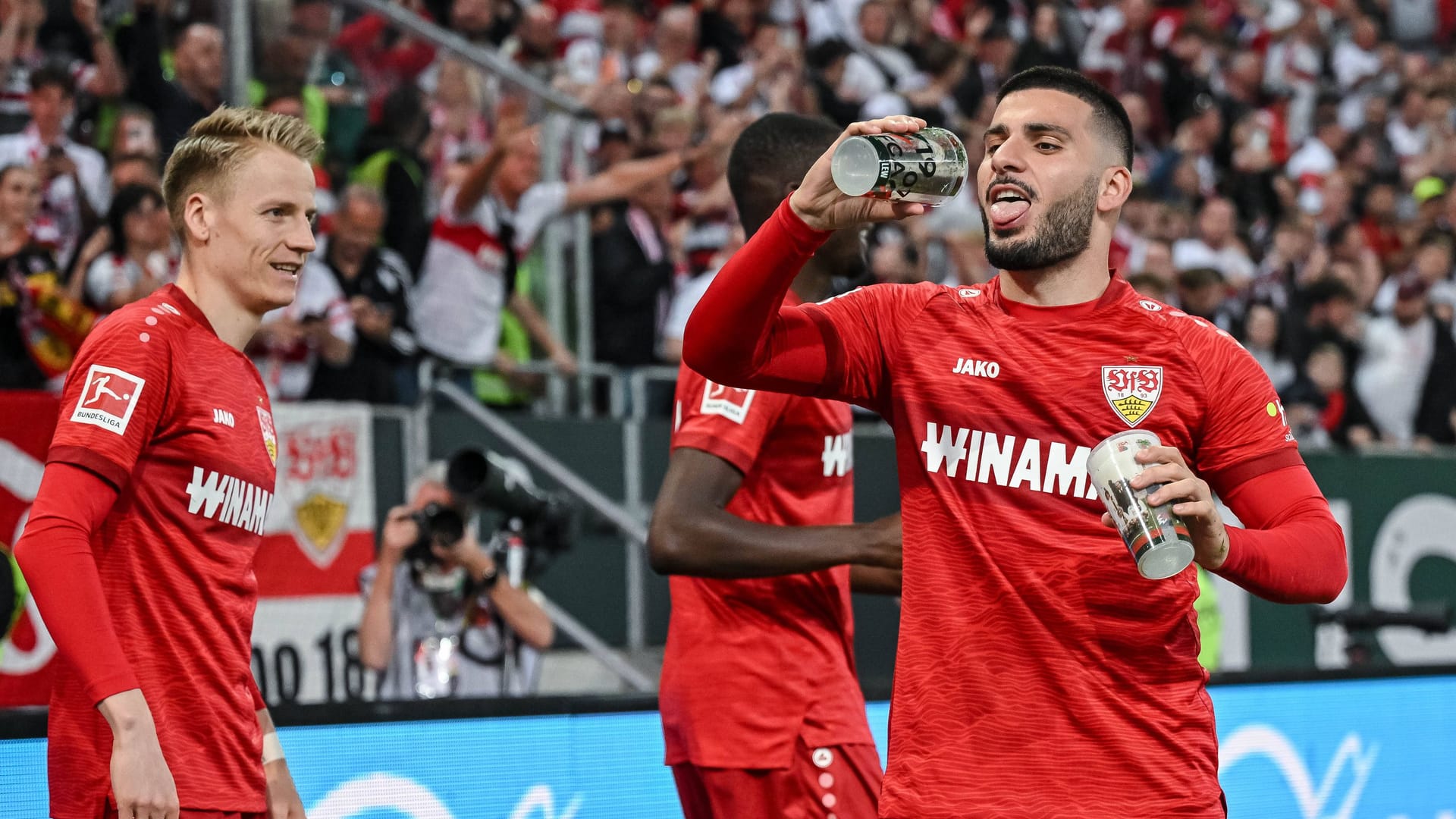 Deniz Undav (rechts) feiert mit Bierbechern: Stuttgart springt zumindest vorübergehend auf Platz zwei der Bundesliga-Tabelle.