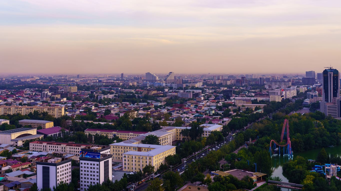 Uzbekistan, Tashkent - September 29, 2023: Top view from the observation deck on the Tashkent TV tower to the central part of the city covered with smog at sunset . Air polution.